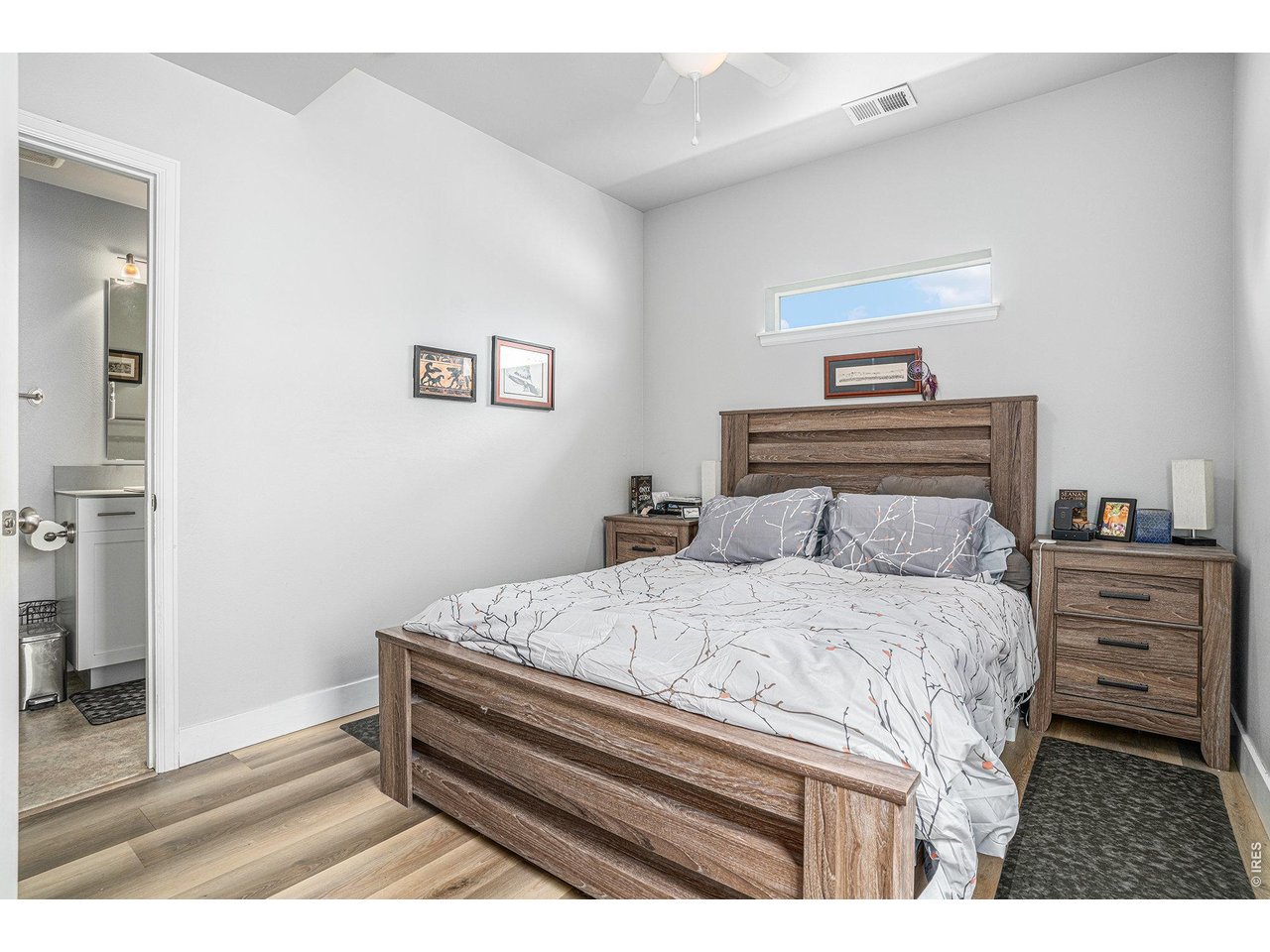 7775 5th Street, Unit 2 Wellington, CO 80549 - Photo 15 of 30 a bedroom with a bed and a painting on the wall