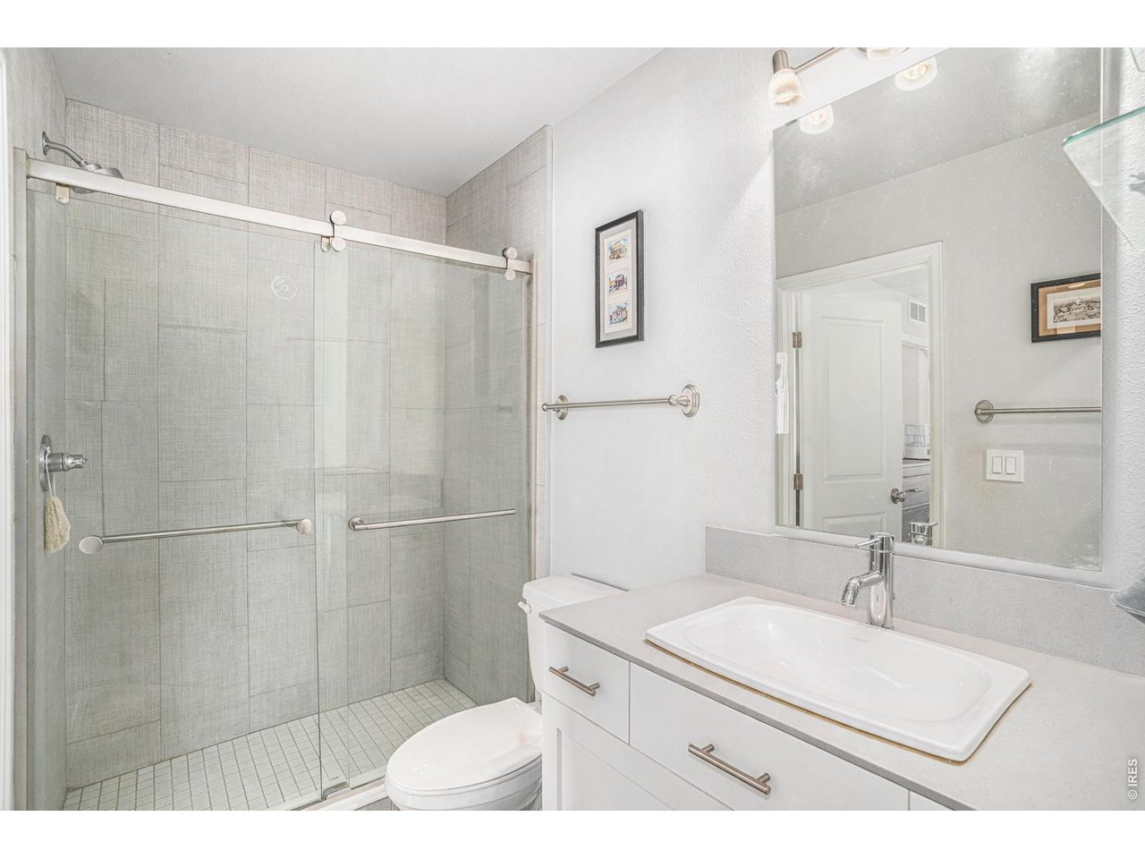 7775 5th Street, Unit 2 Wellington, CO 80549 - Photo 17 of 30 a bathroom with a sink toilet a mirror and shower
