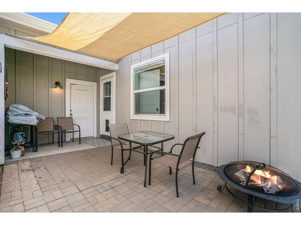 a view of a dinning table and chairs in a patio