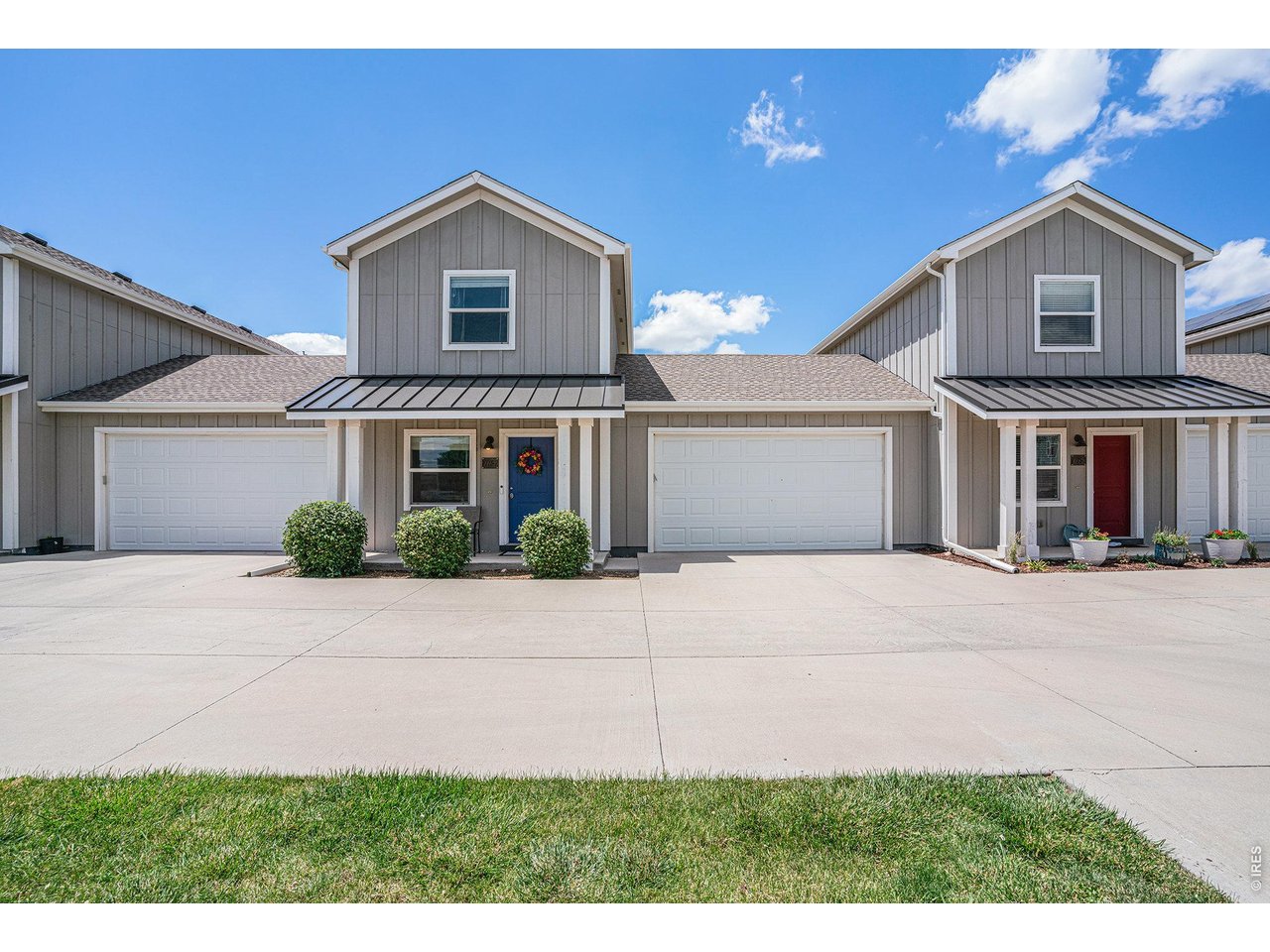 7775 5th Street, Unit 2 Wellington, CO 80549 - Photo 4 of 30 a front view of a house with a yard and garage