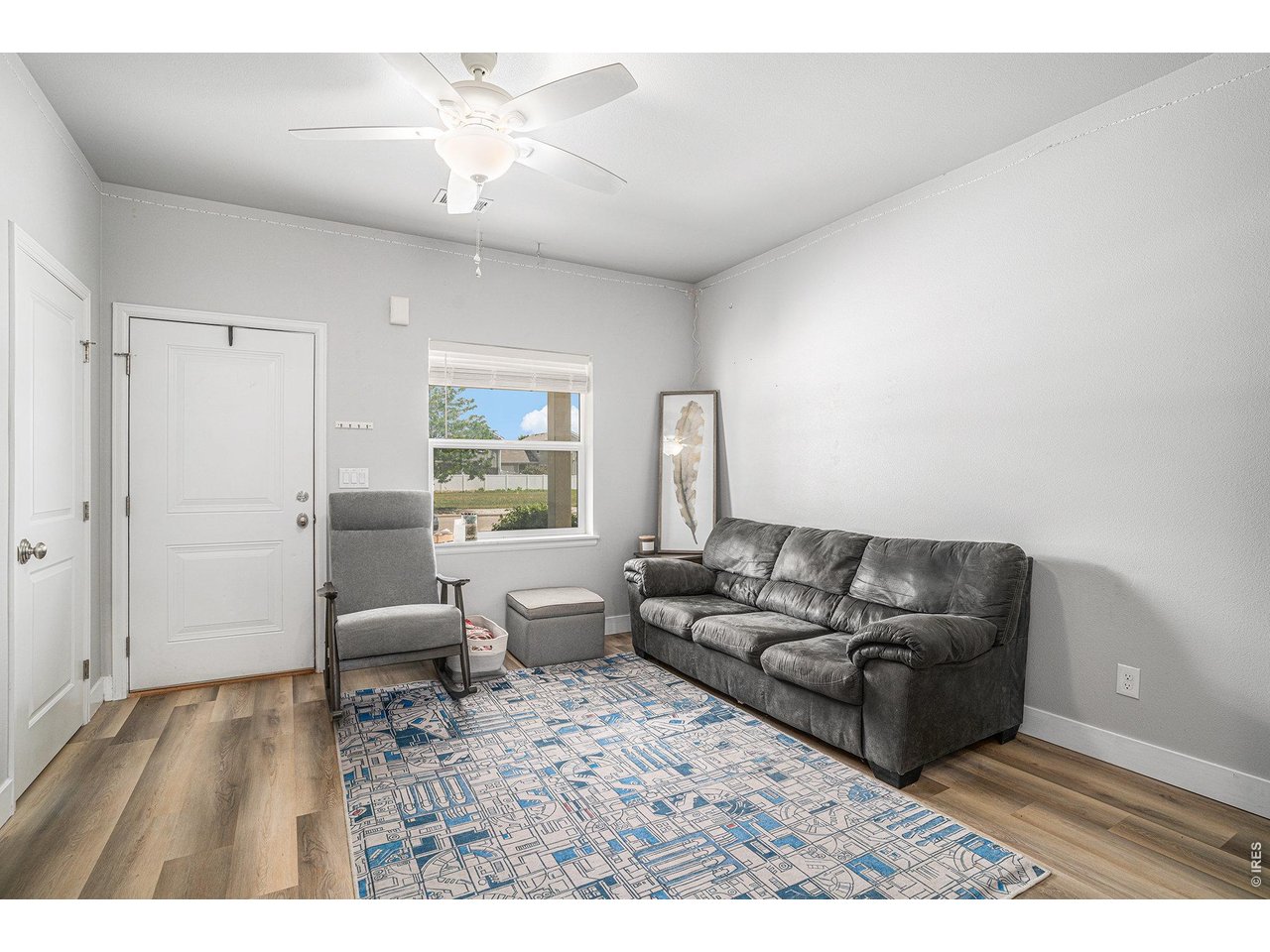 7775 5th Street, Unit 2 Wellington, CO 80549 - Photo 8 of 30 a living room with furniture and a wooden floor