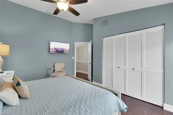 a bedroom with a bed and a ceiling fan