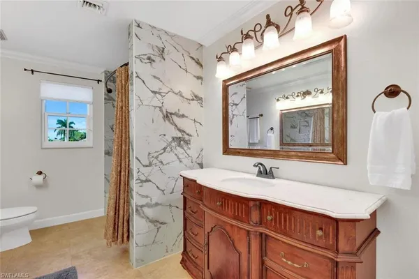 a bathroom with a sink a toilet and shower curtain
