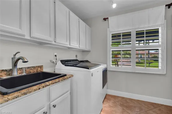 a kitchen with stainless steel appliances granite countertop a stove and a white cabinets