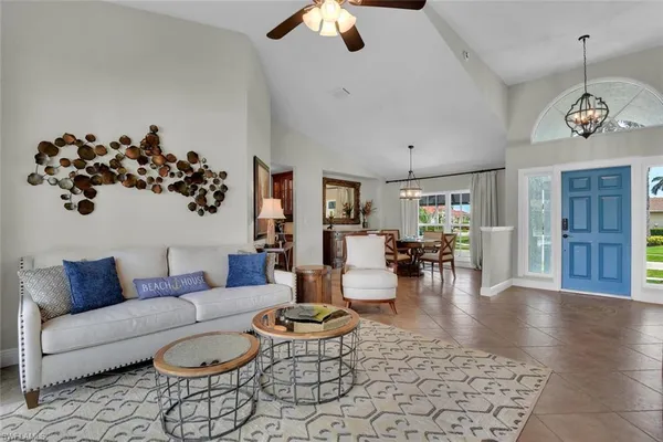 a living room with furniture bathtub and view of kitchen