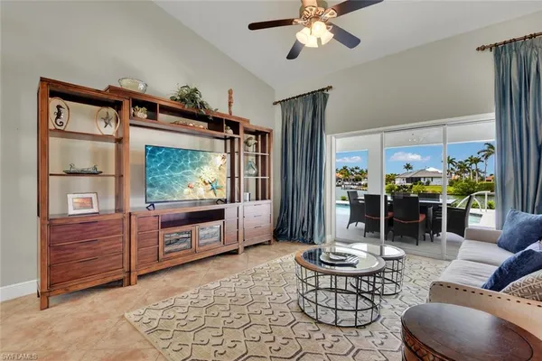 a living room with furniture a window and a flat screen television