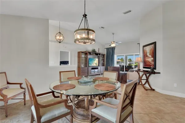 a view of a dining room with furniture and a chandelier