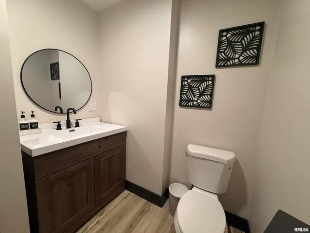 a bathroom with a toilet a sink and mirror