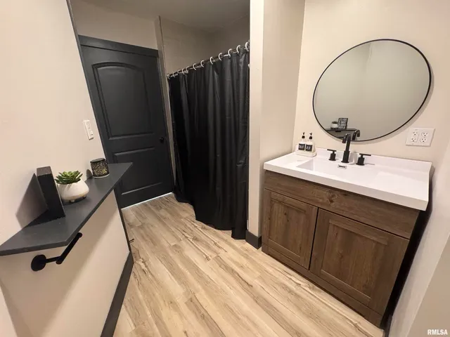 a bathroom with a sink vanity toilet and a mirror