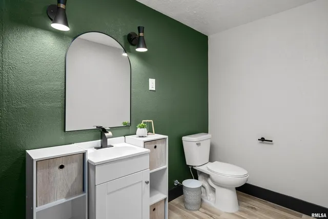 a bathroom with a toilet sink and mirror