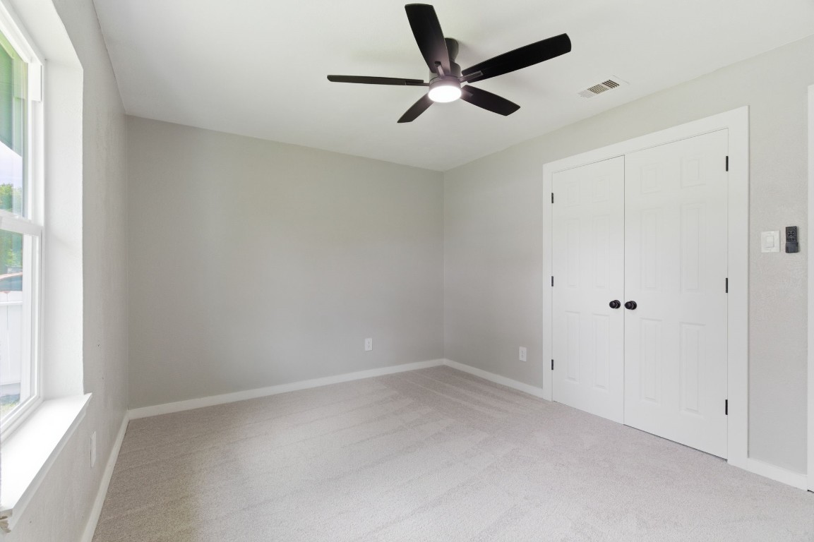 2208 Merle Street Pasadena, TX 77502 - Photo 14 of 26 an empty room with a window and a ceiling fan