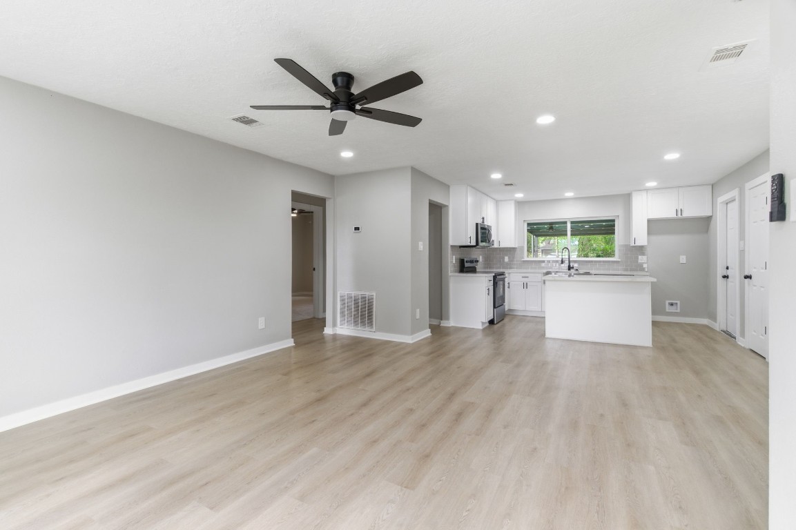 2208 Merle Street Pasadena, TX 77502 - Photo 4 of 26 a view of a big room with wooden floor and windows