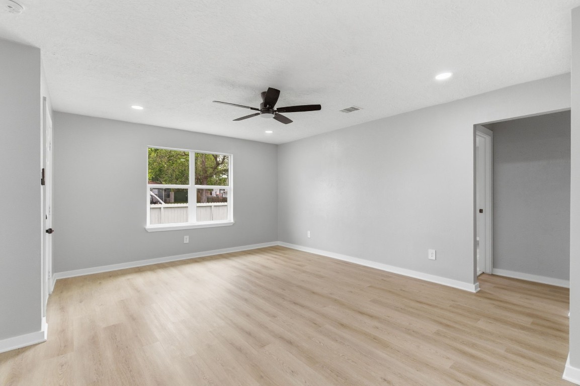 2208 Merle Street Pasadena, TX 77502 - Photo 5 of 26 an empty room with wooden floor and windows