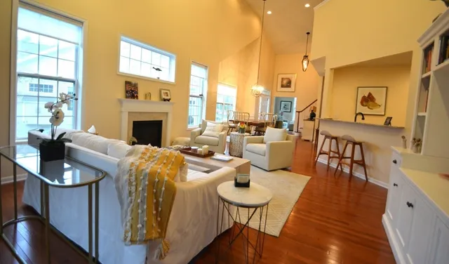 a living room with furniture fireplace and a large window