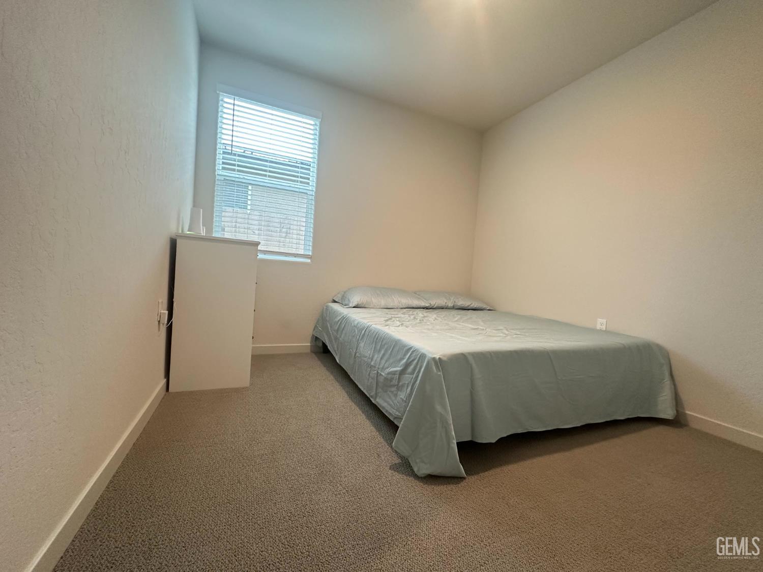 Undisclosed Address Hanford, CA 93230 - Photo 25 of 26 a spacious bedroom with a bed and a window