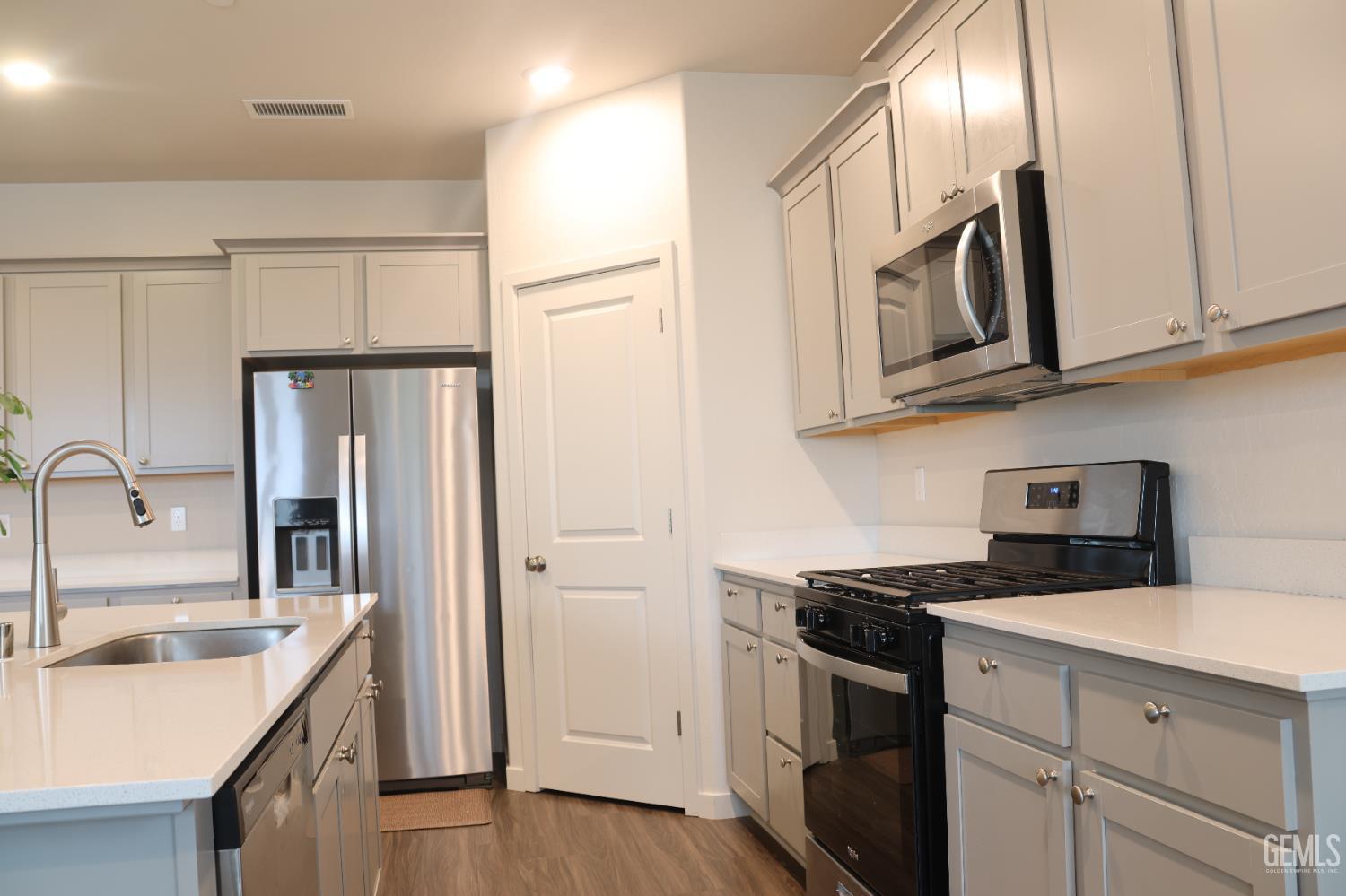 Undisclosed Address Hanford, CA 93230 - Photo 5 of 26 a kitchen with stainless steel appliances granite countertop a sink stove and refrigerator