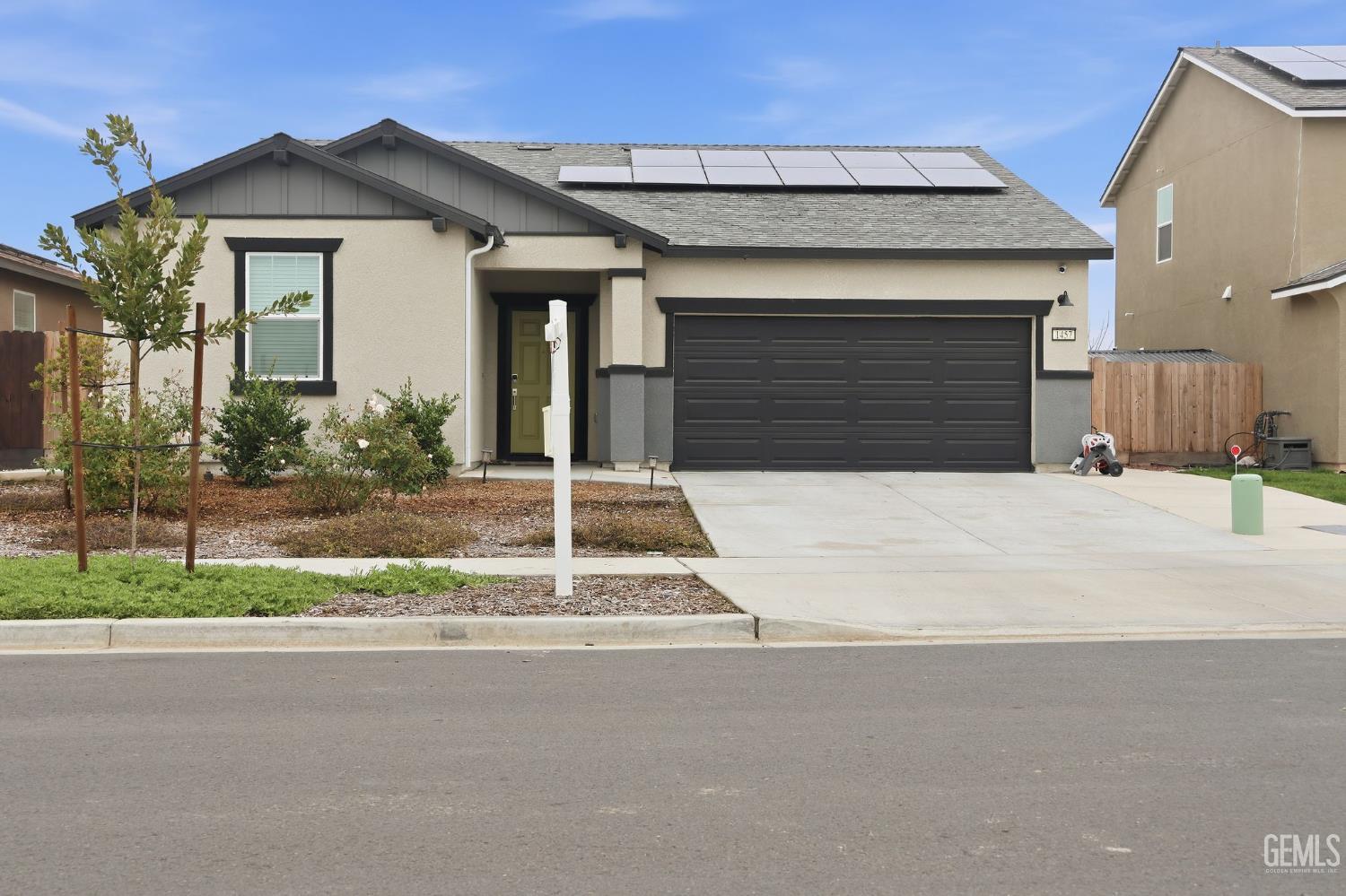 Undisclosed Address Hanford, CA 93230 - Photo 8 of 26 a front view of a house with a yard and garage