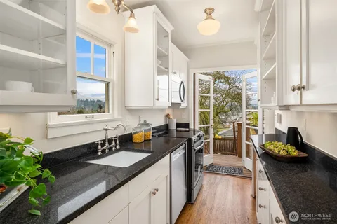 a kitchen with a sink stove and cabinets