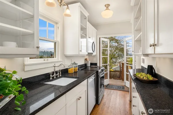 a kitchen with a sink stove and cabinets