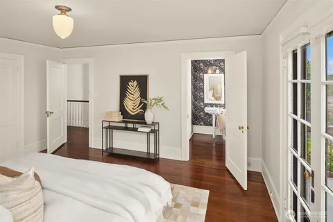 a bedroom with a bed and a table