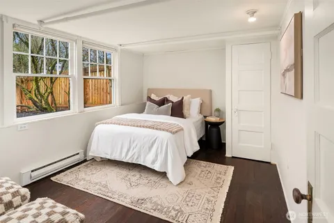 a bed sitting in a bedroom next to a window