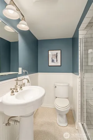 a bathroom with a toilet sink and mirror