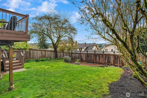 a view of a backyard with a small cabin and wooden fence