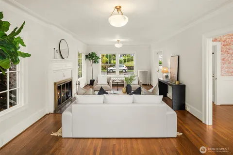 a living room with furniture a fireplace and a chandelier