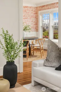 a living room with furniture and potted plants