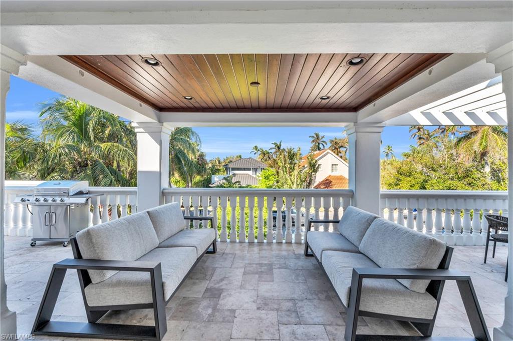 271 Broad Avenue South, Unit 203 Naples, FL 34102 - Photo 11 of 16 a view of a chairs and table in patio