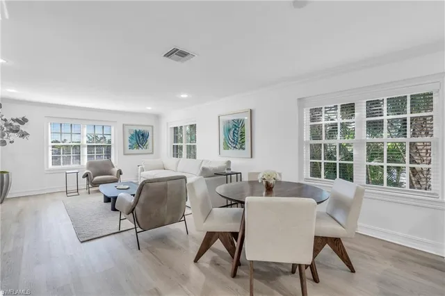 a living room with furniture and two window