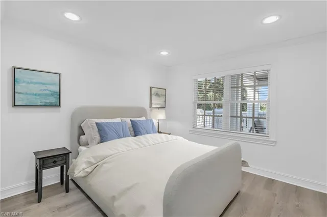 a bedroom with a large bed and a window