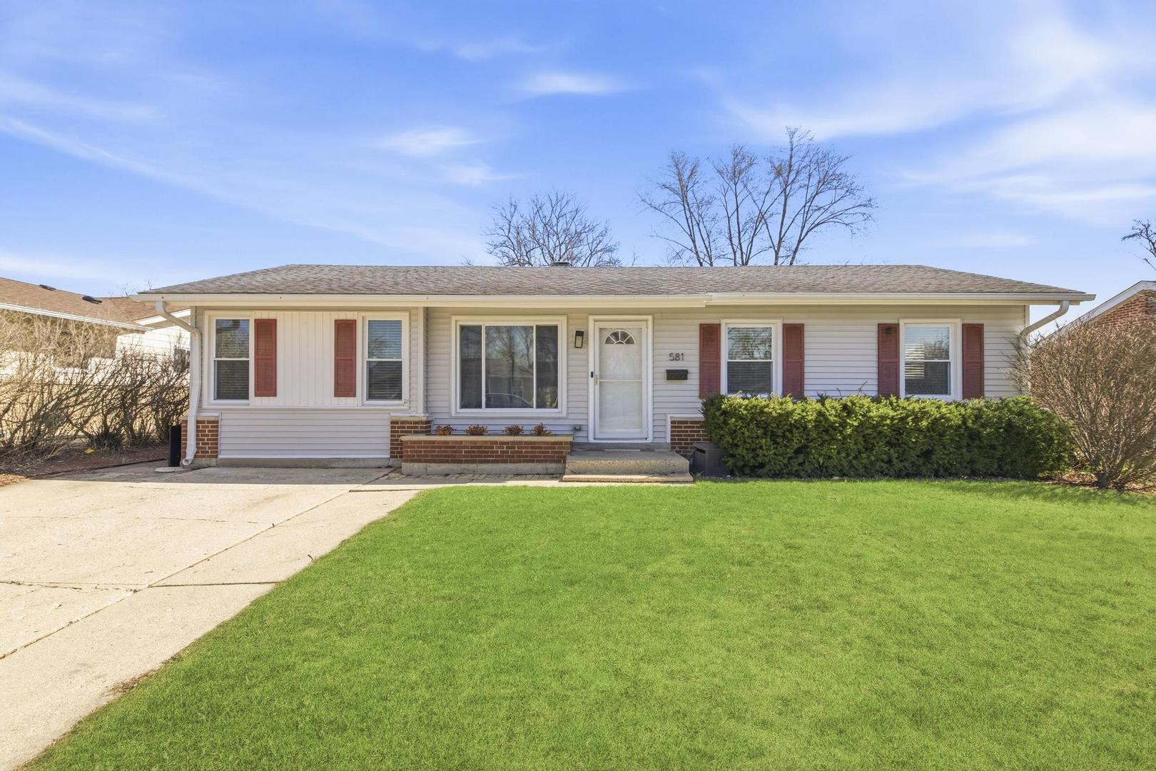 a front view of a house with yard patio and green space