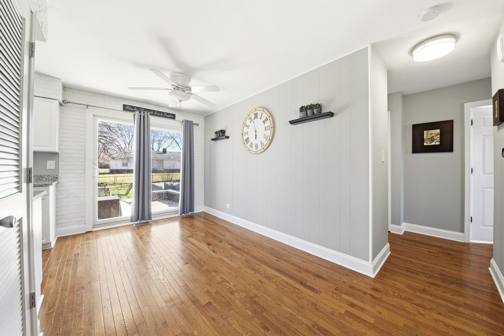 581 Charing Cross Road Elk Grove Village, IL 60007 - Photo 11 of 18 an empty room with wooden floor and windows