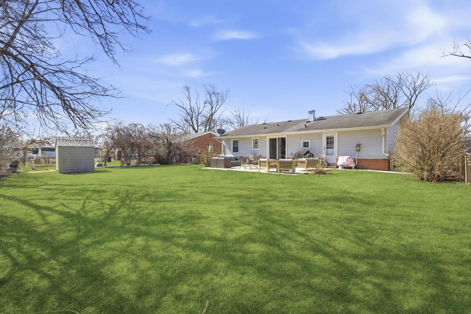 581 Charing Cross Road Elk Grove Village, IL 60007 - Photo 17 of 18 a view of house with a big yard