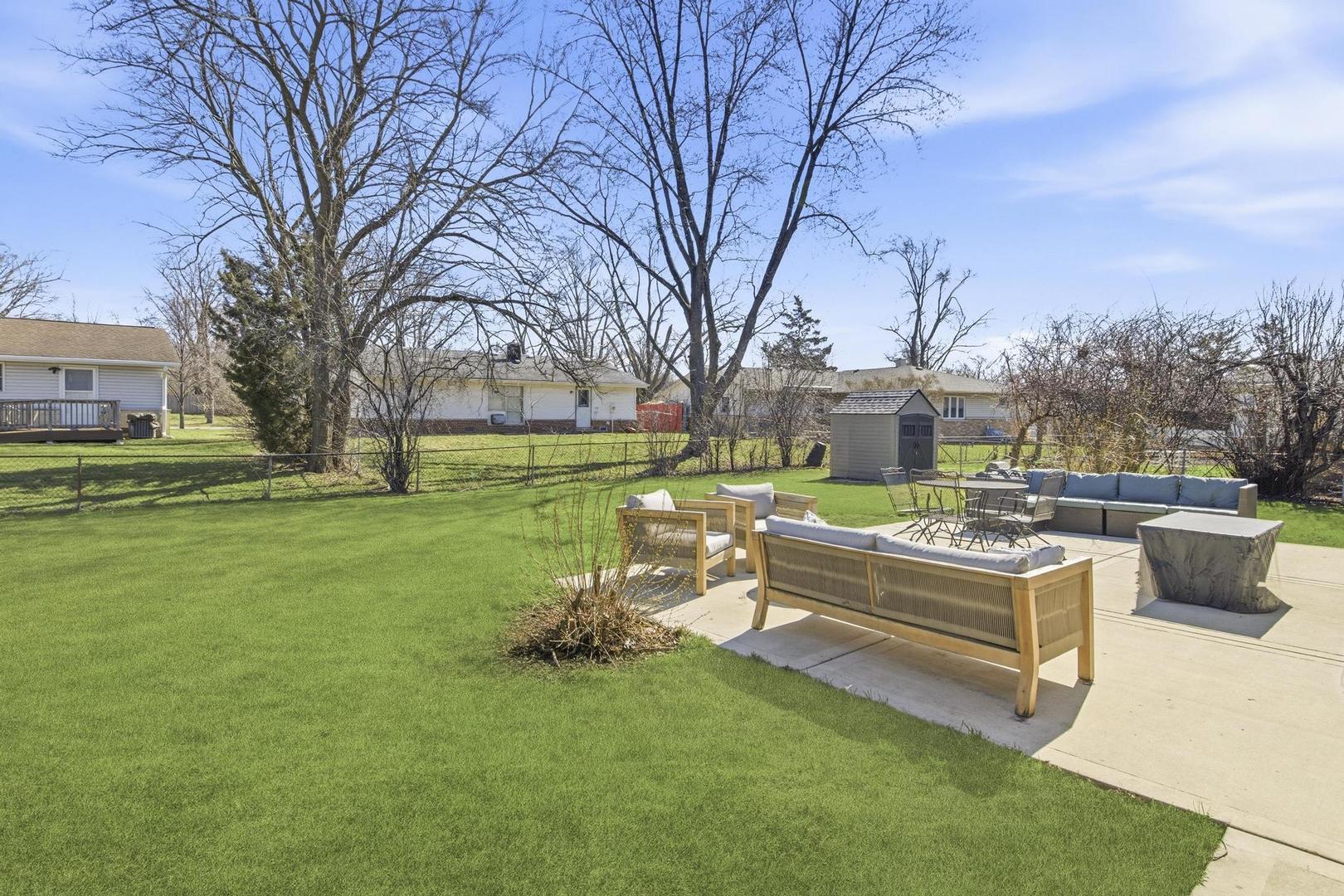 581 Charing Cross Road Elk Grove Village, IL 60007 - Photo 18 of 18 a front view of a house with garden and sitting area