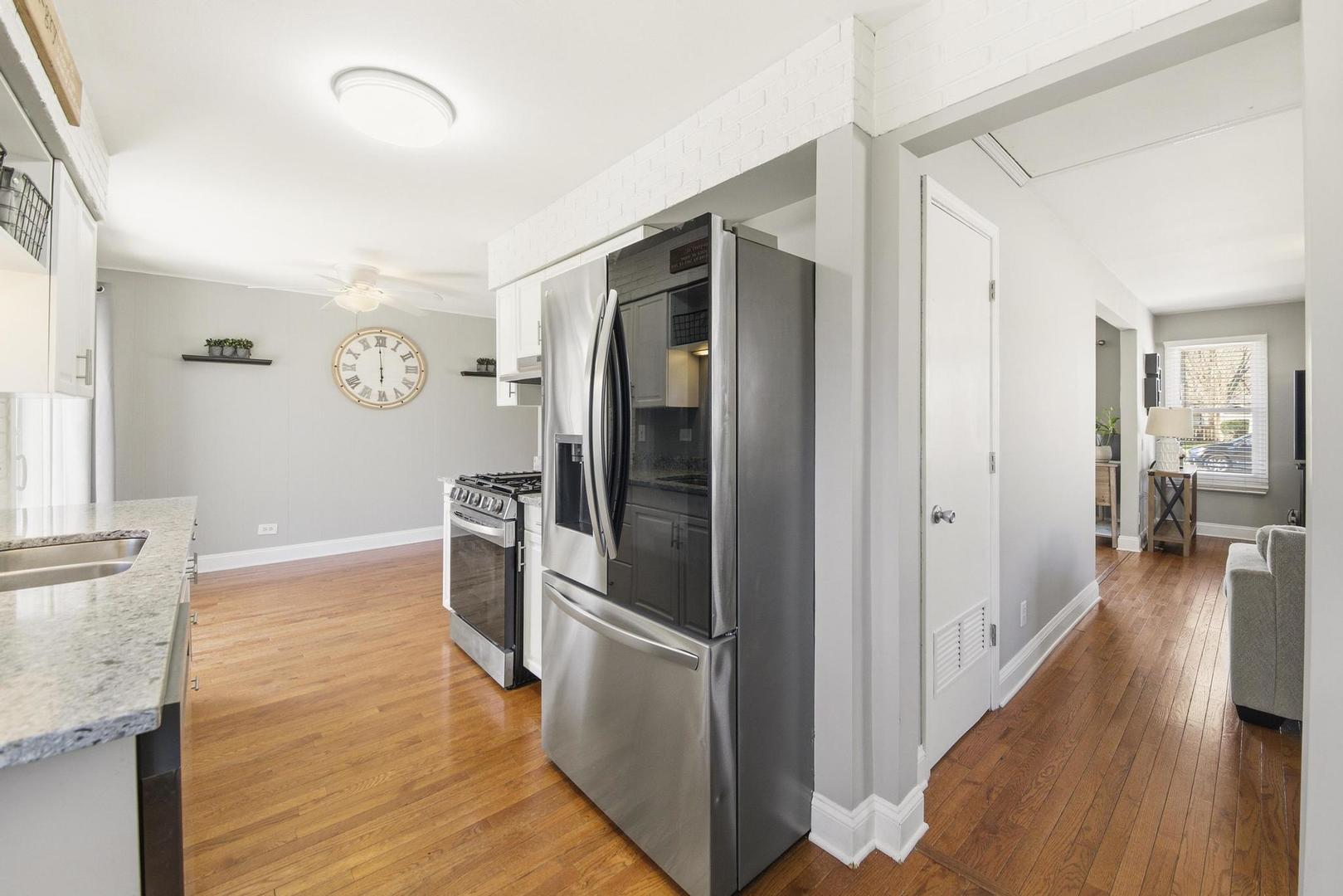 581 Charing Cross Road Elk Grove Village, IL 60007 - Photo 8 of 18 a kitchen with a refrigerator and a sink