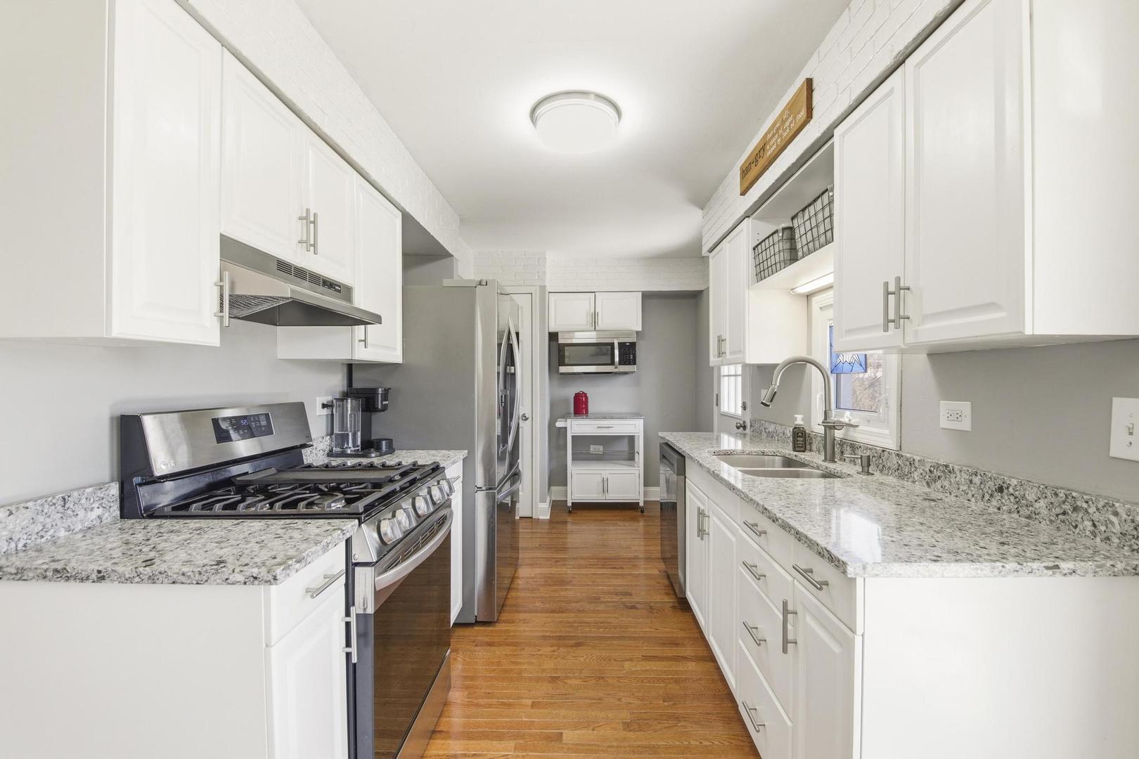 581 Charing Cross Road Elk Grove Village, IL 60007 - Photo 9 of 18 a kitchen with stainless steel appliances granite countertop a stove a sink and a refrigerator