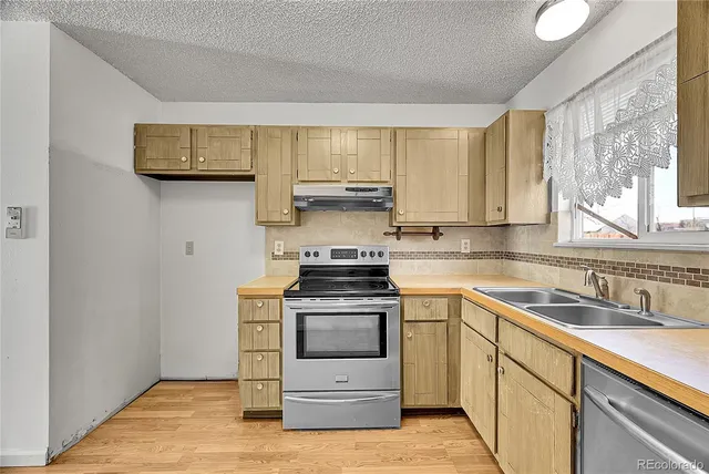 a kitchen with a stove and a sink