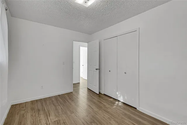 a view of an empty room and wooden floor