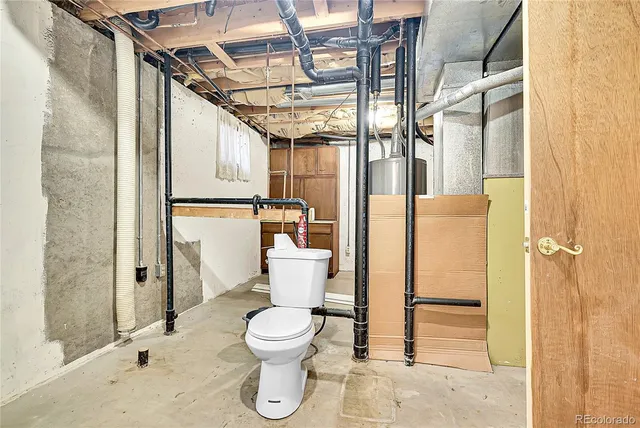 a white toilet sitting next to a bathroom