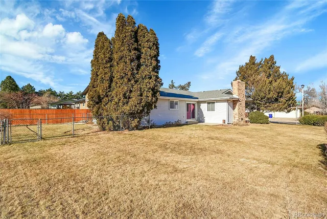 a backyard of a house with wooden fence