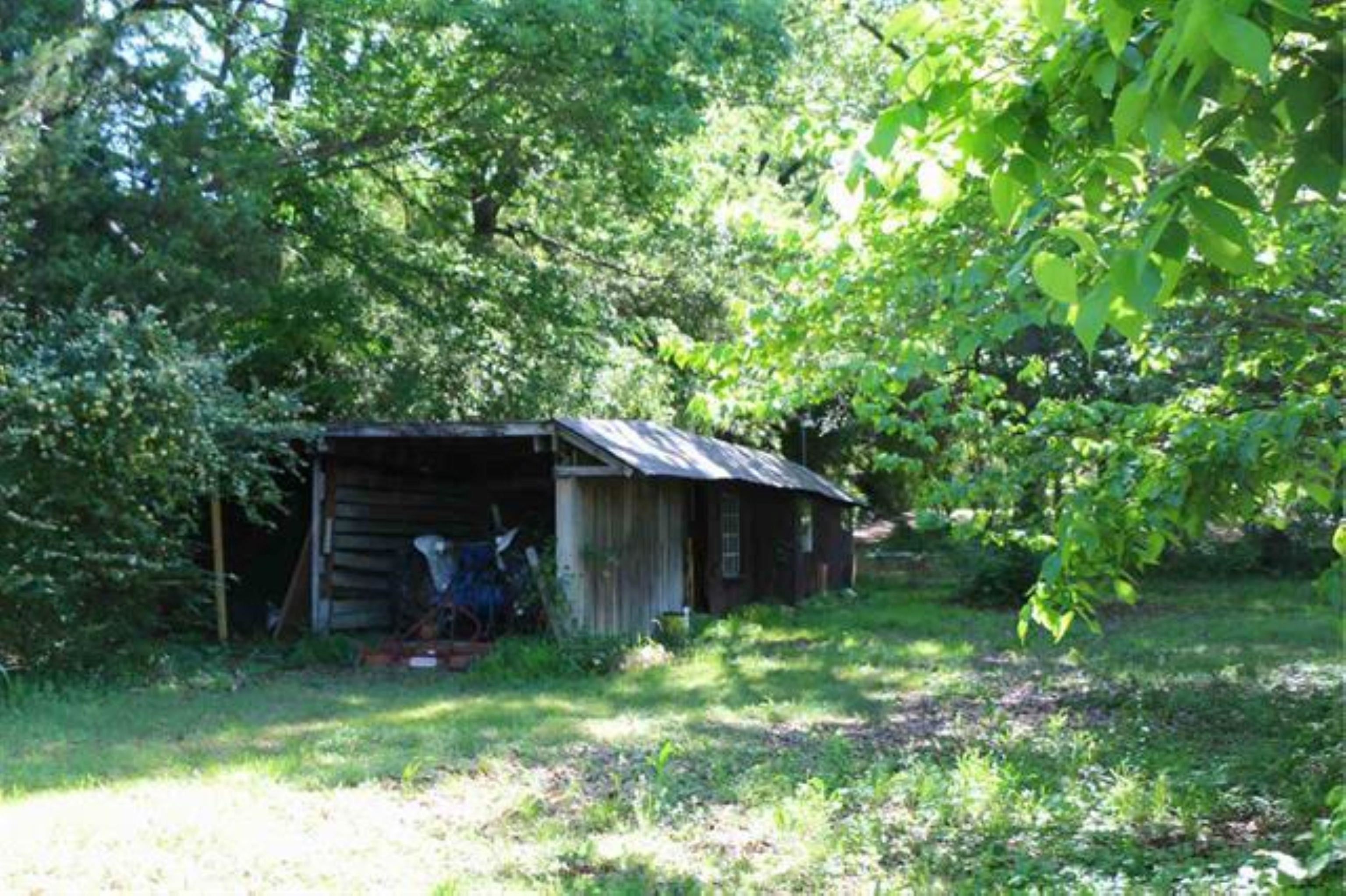 3515 Hacks Cross Road Memphis, TN 38119 - Photo 11 of 12 a view of a backyard with table and chairs and a large tree