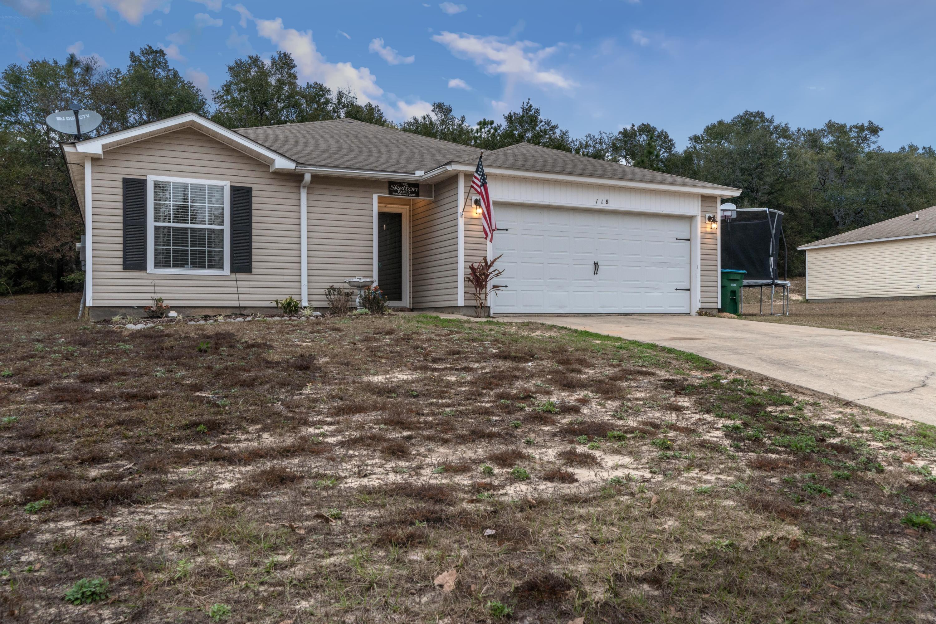 118 Cabana Way Crestview, FL 32536 - Photo 2 of 22 a front view of a house with a garden