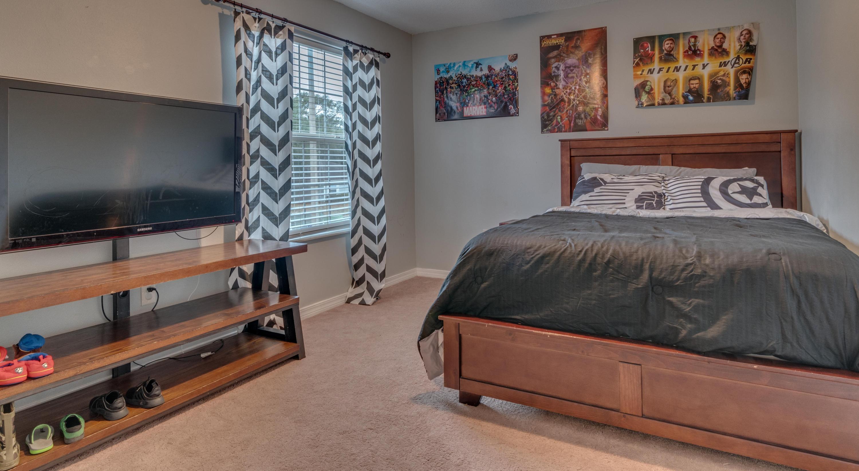 118 Cabana Way Crestview, FL 32536 - Photo 20 of 22 a bedroom with a bed and paintings on the wall