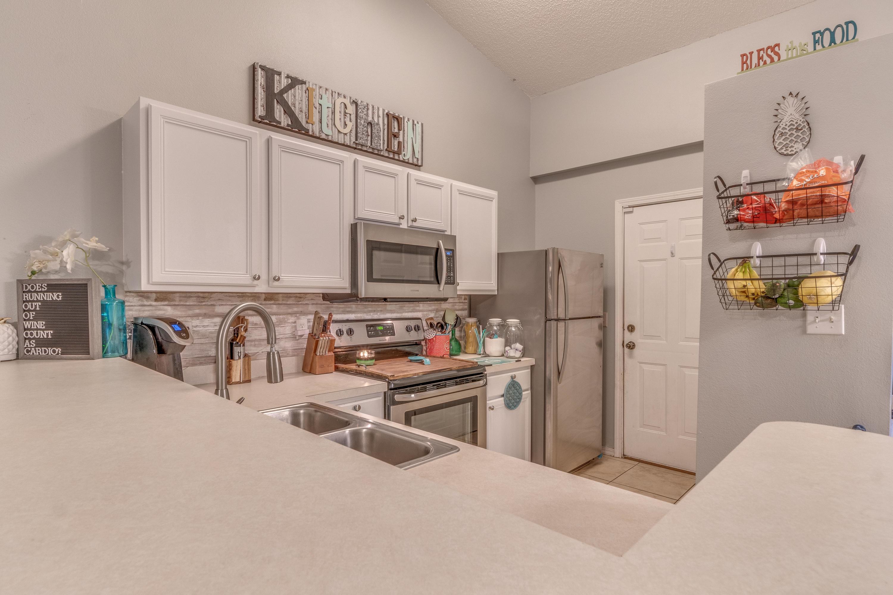 118 Cabana Way Crestview, FL 32536 - Photo 4 of 22 a kitchen with stainless steel appliances a refrigerator and a stove top oven