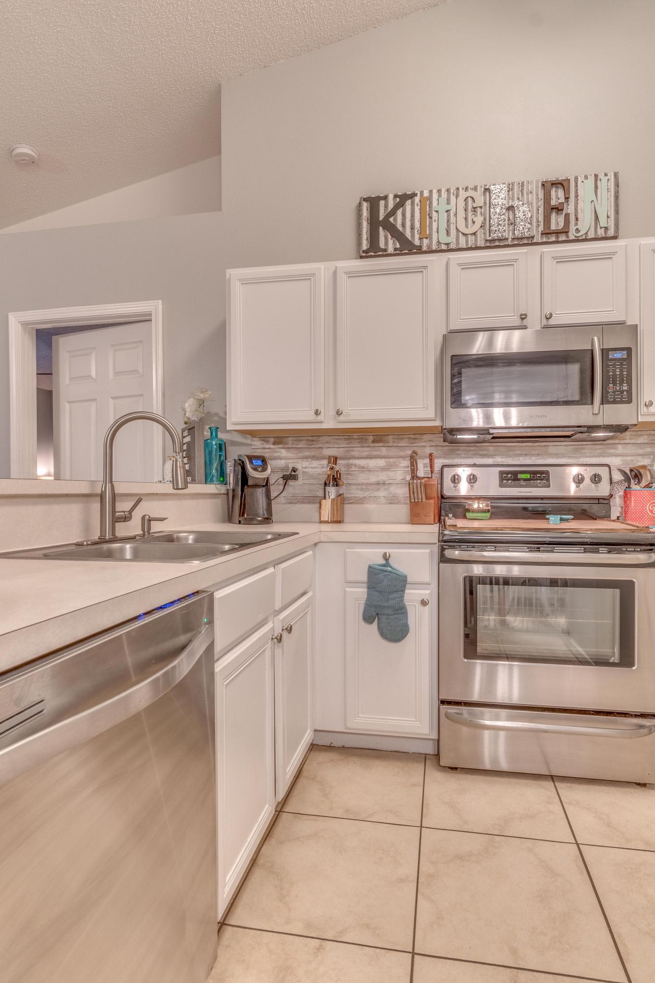 118 Cabana Way Crestview, FL 32536 - Photo 5 of 22 a kitchen with cabinets appliances and a sink