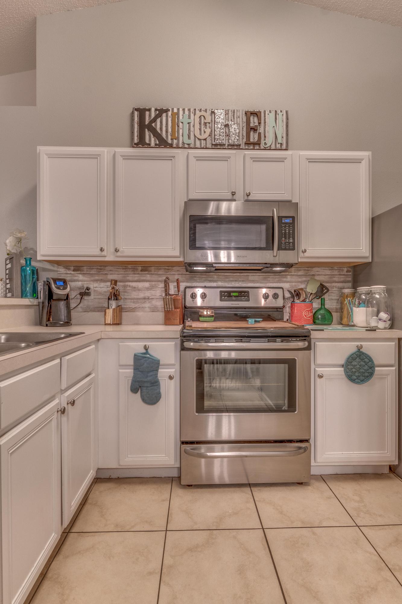 118 Cabana Way Crestview, FL 32536 - Photo 6 of 22 a kitchen with white cabinets and white appliances