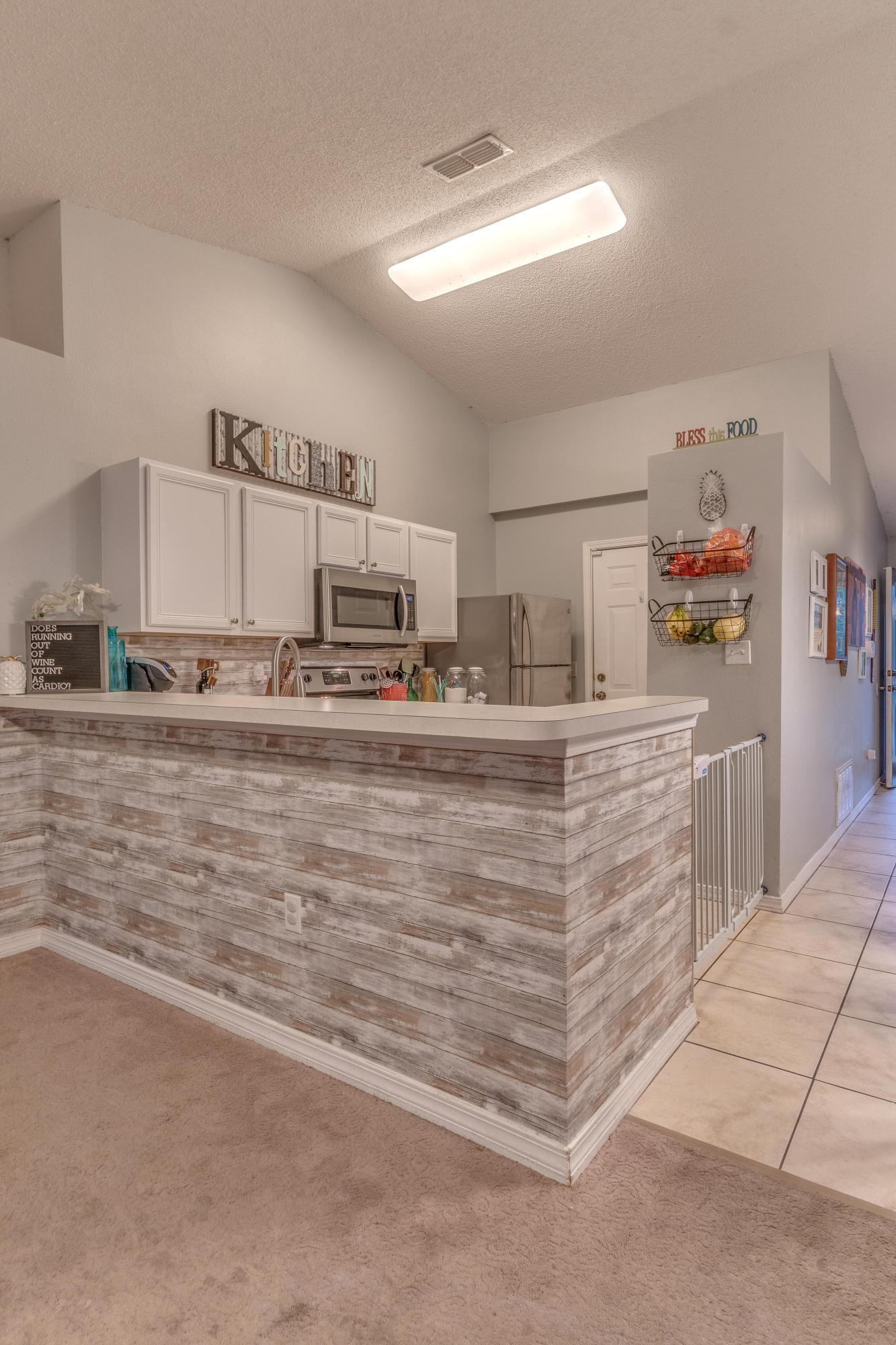 118 Cabana Way Crestview, FL 32536 - Photo 7 of 22 a kitchen with kitchen island cabinets and a sink