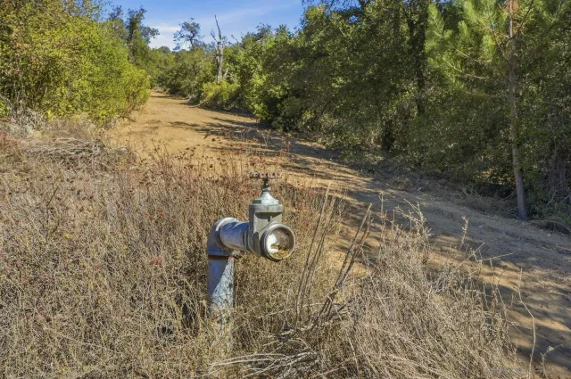 a view of a field with mountains in the background